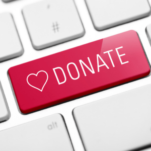 Red "Donate" button with heart icon on computer keyboard