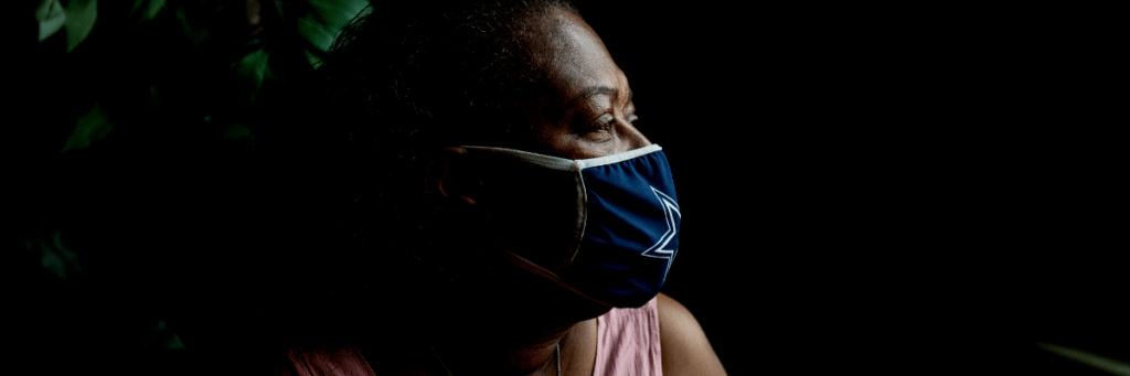 EOC participant, Rhonda, wears blue face mask while looking out the window