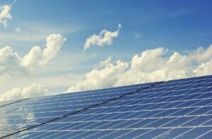 photovoltaic solar panels sits against blue sky