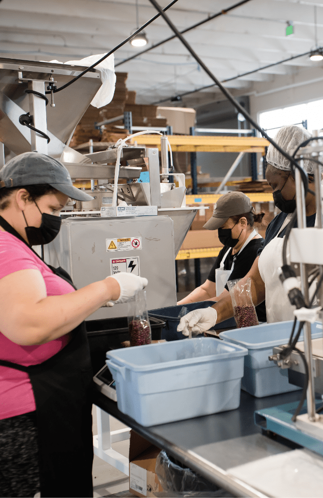Women work in the new Women's Bean Project facility