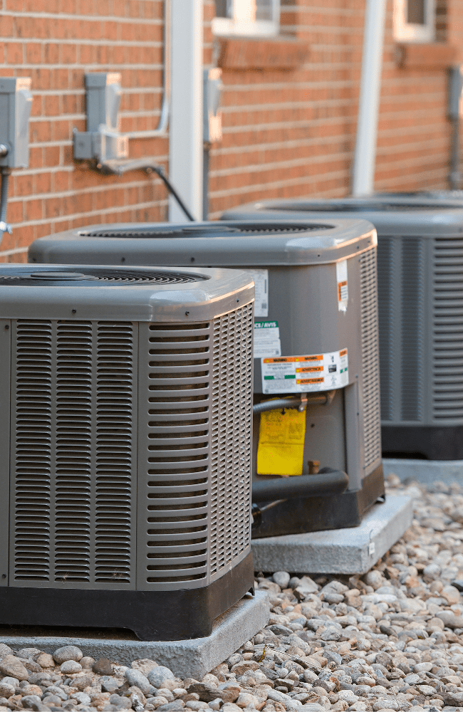 New AC units align the walll outside of a multifamily building