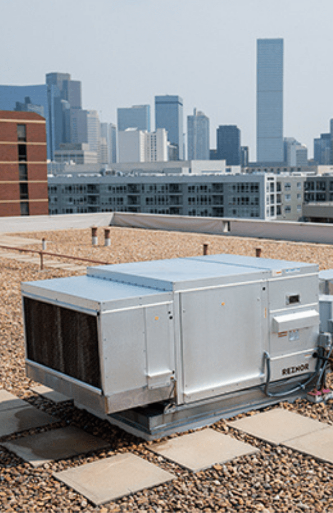 Rooftop AC unit with Denver skyline in the background