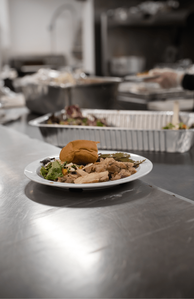 A plate filled with turkey, salad and fresh bread sits at the Haven of Hope kitchen counter